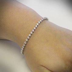 Your lady would love gorgeous diamonds to grace her wrist. If you are into top quality, then you will appreciate this premium quality diamond bracelet. First the design. Using minimal metal on the top the focus is on the diamonds. Gleaming brilliant white diamonds will line her wrist. Using 3 prongs for minimal metal. The diamonds used in this bracelet are Premium Cut for maximum sparkle. They are bright white color, G-H, and have good clarity, SI1-SI2. By contrast, the low end bracelets at Zale Tennis Bracelet Diamond, Sea Glass Jewelry, Diamond Bracelets, Metal Bracelets, White Diamonds, Tennis Bracelet, Quality Diamonds, Crystal Bracelets, Bracelet Gift