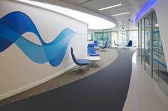 an office with curved walls and blue chairs