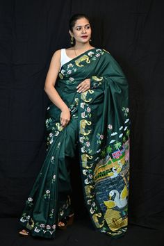 This authentic patachitra silk saree has an artistic depiction of motifs that illustrates a story. The painting on the saree is the handwork of the artists that the district of Puri is famous for. These are storytelling fabrics. This is a genuine handwoven piece, unevenness in the selvedge and weave could be expected, and colors may fade or bleed due to the traditional dyeing method employed. Specification: Occasion: Festive Wear Fabric: Pure Silk Primary Color: Green Secondary Color: Green Material :  Pure Silk Pattern: Motif Border Type: Handicrafts Border Size: Medium Blouse Piece: Included Care: Dry Clean Disclaimer : This is a genuine handwoven piece, & that could expect unevenness in the selvedge and weave, and colours may fade or bleed due to the traditional dyeing method employed. Patachitra Paintings Saree, Artistic Saree With Motifs For Navratri, Artistic Unstitched Art Silk Saree, Artistic Katan Silk Saree, Artistic Saree With Motifs In Art Silk, Artistic Art Silk Saree With Motifs, Green Traditional Wear With Kalamkari Print, Artistic Embroidered Dupatta For Festivals, Artistic Katan Silk Saree For Festivals