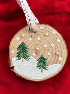 a wooden ornament with trees painted on it