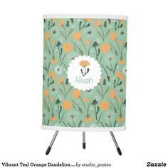 an orange and green flowered lamp shade with the name algon on it's side