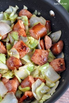 sausage and cabbage cooking in a skillet