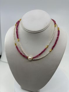 New handcrafted double strand necklace, a perfect symphony of pink faceted tourmaline and delicate white baby pearls. This exquisite piece is designed to bring a touch of quiet luxury to any outfit, ideal for those who appreciate the finer details in life. Measurements and Materials:         *       Tourmaline: 3mm faceted rondelles, showcasing a vibrant pink hue that captures the beauty of fall.         *       Pearls: White freshwater baby pearls ranging from 2 to 3mm, meticulously selected fo Watermelon Tourmaline Necklace, Baby Pearls, Double Strand Necklace, Tourmaline Necklace, Quiet Luxury, Watermelon Tourmaline, Pearl Charms, Cross Designs, Pink Pearl