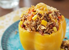 a stuffed bell pepper is on a blue plate