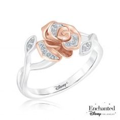 a rose shaped ring with diamonds on the band and two tone gold petals in the center