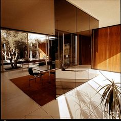 a glass walled room with a table and chairs