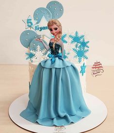 a birthday cake with a frozen princess figure on top