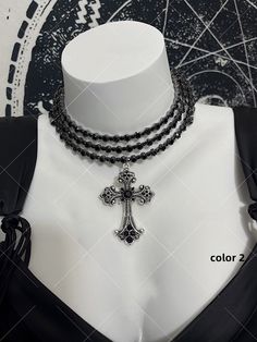 Embrace the edgy and punk-inspired aesthetic with our gothic punk Y2K cross choker. This subculture-inspired gothic choker features multiple layers and is designed to accentuate your collarbone for a striking look.  Please note that this product includes only the choker. Gothic Metal Choker For Concerts, Gothic Necklace For Halloween Concert, Gothic Choker For Halloween Concert, Gothic Choker For Concert, Silver Emo Choker For Concert, Gothic Choker For Halloween And Alternative Fashion, Gothic Black Metal Cross Necklace, Grunge Choker For Alternative Fashion And Halloween, Emo Choker For Alternative Fashion