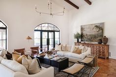 a living room filled with furniture and windows