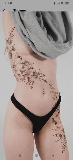 a woman's stomach with flowers on it and the bottom part of her panties