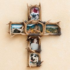 a cross made out of antlers with pictures on it