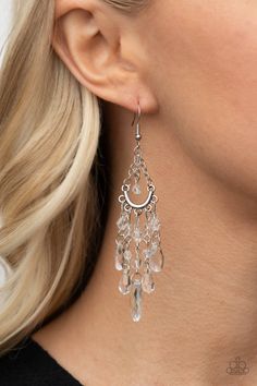 A glassy collection of clear teardrop, oval, and round crystal-like beads taper at the bottom of a silver half moon frame that is suspended by dainty silver chains. Matching beading swings from the top of the frame, creating a whimsical chandelier. Earring attaches to a standard fishhook fitting. Sold as one pair of earrings. Clear Dangle Jewelry For Party, Elegant Dangle Glass Jewelry, Elegant Teardrop Crystal Earrings With Dangling Beads, Elegant Glass Dangle Jewelry, Clear Crystal Dangle Jewelry, Clear Pierced Jewelry For Party, Glass Dangle Jewelry For Parties, Party Glass Dangle Jewelry, Glass Jewelry With Dangling Beads For Party