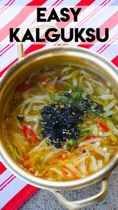 a bowl filled with noodles and broccoli on top of a red and white towel