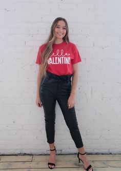 This super soft red tee is perfect to wear for a date with the true love of your life on Valentine's Day. Grab a box of chocolates, a bottle of wine, and cozy up on the couch with this t-shirt and leggings, or layer it with a soft cardigan, jeans and booties for a romantic night out on the town. * Tultex Soft Tee * Screenprinted Fabric Details: - 50% polyester - 50% ring-spun USA cotton * Unisex fit Valentine Outfits For Women, Valentine Outfits, Hello Valentine, Cardigan Jeans, A Box Of Chocolates, Soft Graphic, Box Of Chocolates, A Bottle Of Wine, Love Of Your Life