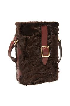 a brown and black furry bag on a white background with a gold buckle in the center