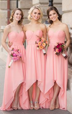 three bridesmaids in pink dresses posing for the camera