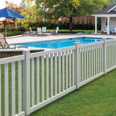 a white fence surrounding a swimming pool