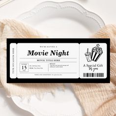 a movie ticket sitting on top of a white plate