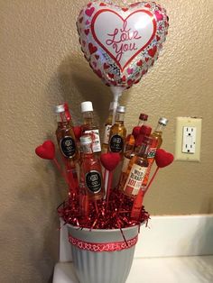 a valentine's day arrangement with hot sauce and condiments in a bucket