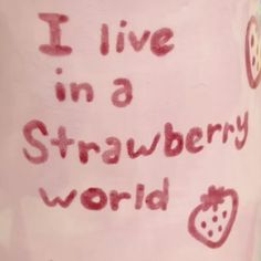 i live in a strawberry world written on a pink cup