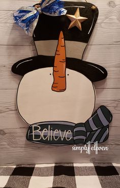 a wooden sign with a hat and carrot on it