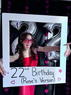 a woman in red dress holding up a sign with the number 22 and birthday rose's version on it