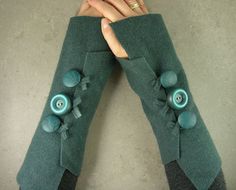 Great idea for fingerless gloves - felt an old sweater, cut it up and add buttons. Or buy this one for $26 on Etsy. Green Fingerless Gloves, Fingerless Arm Warmers, Gloves Fingerless, Recycled Sweaters, Arm Cuffs, Upcycle Sewing, Wool Mittens, Wool Projects, Fingerless Gloves Knitted