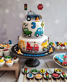 a birthday cake and cupcakes on a table