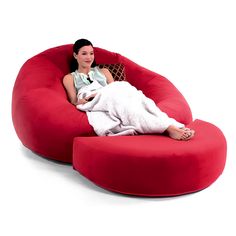 a woman is sitting on a bean bag chair