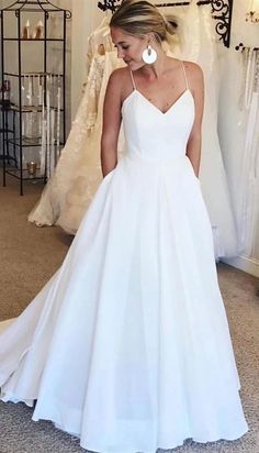 a woman in a white wedding dress looking down