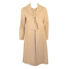 This timeless two piece ensemble is constructed of soft wool in a perfect neutral shade of oatmeal. The coat and dress are fully lined in nylon fabric of the the same shade. Marked a size 10 ILGUW Label inside. Measurements: Coat: Bust: 36" Sleeve: 22.5" Shoulder to shoulder: 15" Length: 42.5" Dress: Bust: 36" Waist:32" Hip: 36" Sleeve: 7" Shoulder to shoulder: 14 1/2" Length: 43" Coat And Dress, Applique Skirt, Silk Jumpsuit, Plaid Suit, 1960's Dress, Vintage Suits, Bill Blass, Mesh Skirt, Dress With Tie