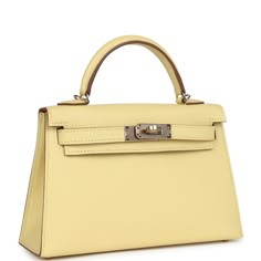 This Special Order Verso Kelly, in the Sellier style, is in Jaune Poussin Epsom leather with permabrass hardware, has tonal stitching, two front straps with front toggle closure, single rolled handle and removable shoulder strap.The interior is lined with Gold leather and has one open pocket on the back wall.Collection: BOrigin: FranceCondition: New and never worn (plastic on hardware)Accompanied by: Hermes box, Hermes dustbag, shoulder strap, shoulder strap dustbag, felt, carebook and ribbonMea Hermes Special Order, Kelly Sellier, Mini Kelly, Hermes Birkin 25, Hermes Box, Luxury Purses, Fancy Bags, Birkin 25, Burberry Shoes