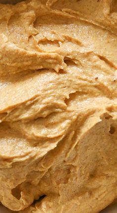 a bowl filled with peanut butter sitting on top of a table