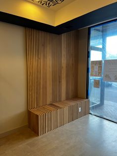 an empty room with wooden slats on the wall