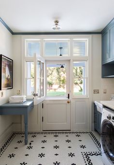 a washer and dryer in a small room with tile flooring on the floor