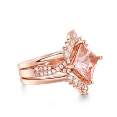 Celebrate your journey of love with this exquisite set, and let its timeless beauty be a reflection of your everlasting commitment. This exquisite ring showcases a mesmerizing princess-cut morganite as its centerpiece, capturing attention with its radiant beauty. The ring's design is a true masterpiece, with a twist motif adorning the ring shank, symbolizing the intertwining of two souls on their journey of love. The intricate details and delicate craftsmanship make this piece a true work of art, blending timeless charm with contemporary flair. Completing the set is two matching bands, perfectly complementing the engagement ring and enhancing its overall splendor. Together, they create a harmonious symphony of beauty and elegance, symbolizing the unity and everlasting bond between two hear Princess Cut Jewelry With Accent Stones, Square Cut Wedding Diamond Ring With Accent Stones, Luxury Rose Gold Topaz Ring For Wedding, Radiant Cut Topaz Ring For Wedding, Square Cut Rings With Accent Stones For Wedding, Luxury Radiant Cut Topaz Wedding Ring, Radiant Cut Morganite Wedding Jewelry, Elegant Bridal Sets With Princess Cut For Promise Ring, Elegant Princess Cut Bridal Promise Ring Set