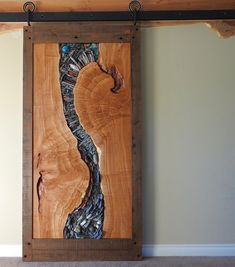 a piece of wood that has been cut into pieces and is hanging on a wall