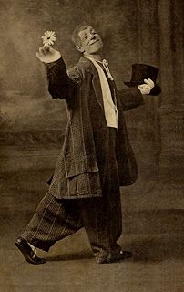 an old photo of a man in a suit and top hat with his arms outstretched