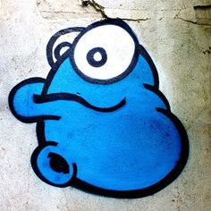 a blue cartoon character painted on the side of a building