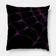 a black and purple spider web pillow on a white background