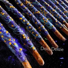 some very pretty looking sticks with yellow and blue designs on them in front of the words dol delizie