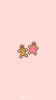 two gingerbreads with pink frosting on them