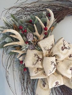 a christmas wreath with deer, pine cones and berries