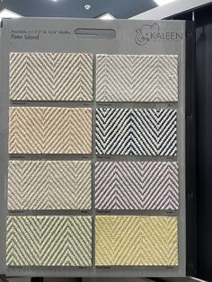 an assortment of woven fabric samples displayed in a display case at a retail store or showroom