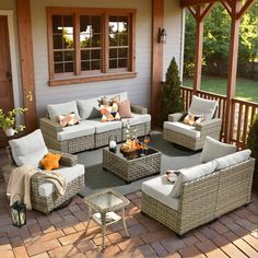 an outdoor living room with wicker furniture