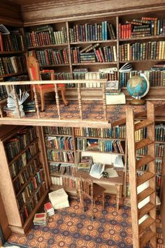 a room filled with lots of books next to a wooden desk and ladder on the floor