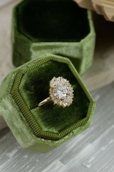 an engagement ring in a green velvet box