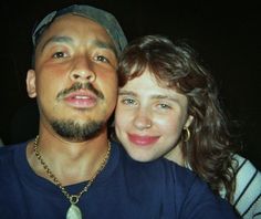 a man and woman are posing for a photo with their heads close to each other