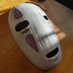 a mask sitting on top of a wooden table