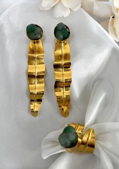 The elegant design, fashion style of the Cata earrings will make you feel more charming. They are lightweight, comfortable for day and night. You'll find these will be your new favorite earrings. DETAILS - Material: 24k gold plated bronze and raw emerald - Weight: 6 gr - Keep it away from water, sweat, perfumes and lotions. - Store your jewelry in their original packaging or a soft pouch. Elegant Green Hammered Earrings, Gold Emerald Earrings For Gift, Elegant Gold Emerald Earrings, Gold Emerald Dangle Earrings, Raw Emerald, Lotus Earrings, Day And Night, Design Fashion, Artisan Jewelry